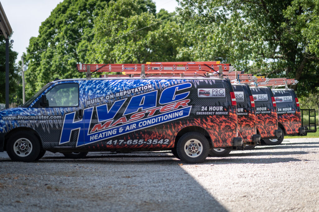 Technician servicing central air handler in attic for HVAC Master LLC residential client