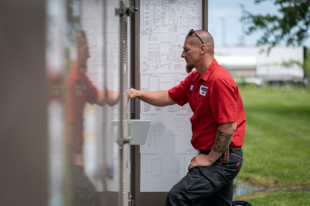 HVAC Master LLC technician servicing outdoor AC condenser at a suburban home