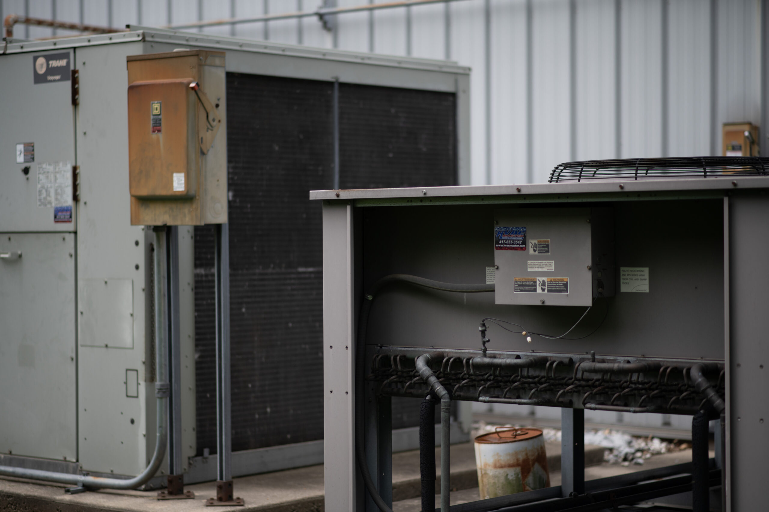 HVAC Master Heating & Air Conditioning LLC technician servicing residential AC unit, model 167-DSC_0720