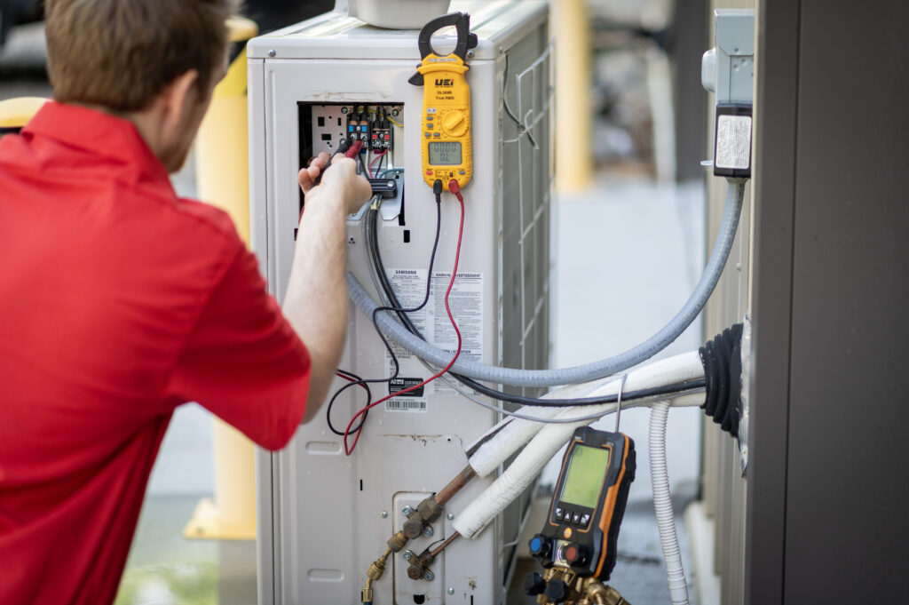 HVAC Master technician servicing central air conditioner condenser outdoors